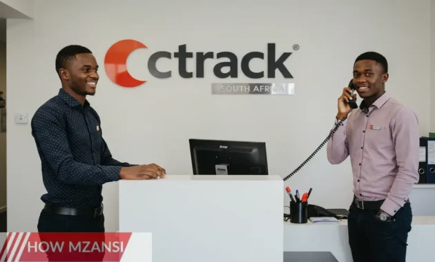 an image showing two young South African professionals (age 18-29) in a modern office reception area, wearing smart casual attire. One is greeting a visitor with a smile, and the other is answering a phone. The background should show the Ctrack logo, clean décor, and elements of a front desk (computer, files, office supplies).